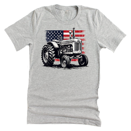 Grey unisex short-sleeve t-shirt with a graphic of a vintage tractor and the American flag in red, white, and blue colors.