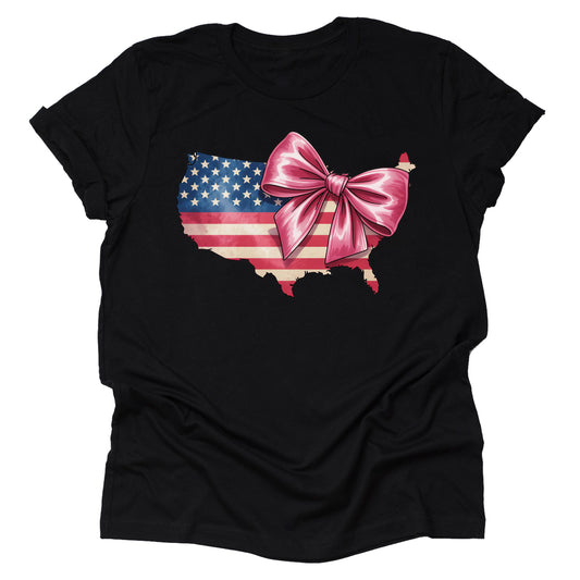 A casual short sleeve unisex T-shirt in black, featuring a silhouette of the United States filled with an American flag design and a large pink bow.
