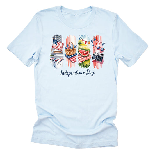 A casual light blue short-sleeve unisex T-shirt in light color, featuring a brushstroke design with red, white, and blue colors and the text 'Independence Day'.