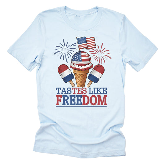 A casual short-sleeve unisex T-shirt with a graphic that includes an ice cream cone with the American flag and the text 'TASTES LIKE FREEDOM' on it, in a light blue color.
