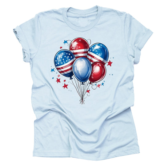 A casual short-sleeve unisex T-shirt in a light blue color, featuring a design with red, white, and blue balloons adorned with stars and stripes, reminiscent of the American flag.