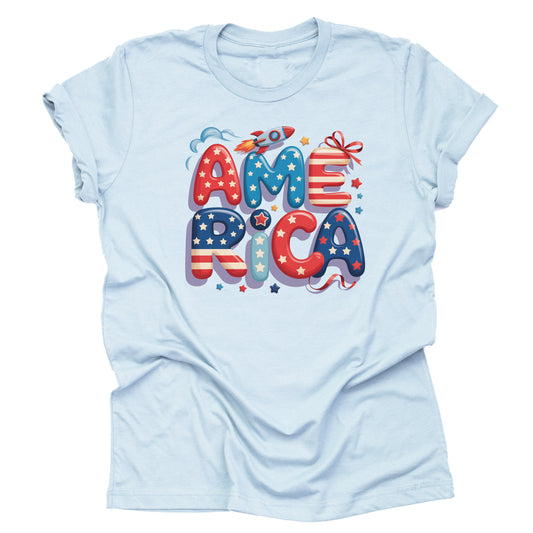 A light blue short-sleeved unisex T-shirt with a graphic that spells out 'america' in stylized lettering, featuring stars and stripes in red, white, and blue colors.